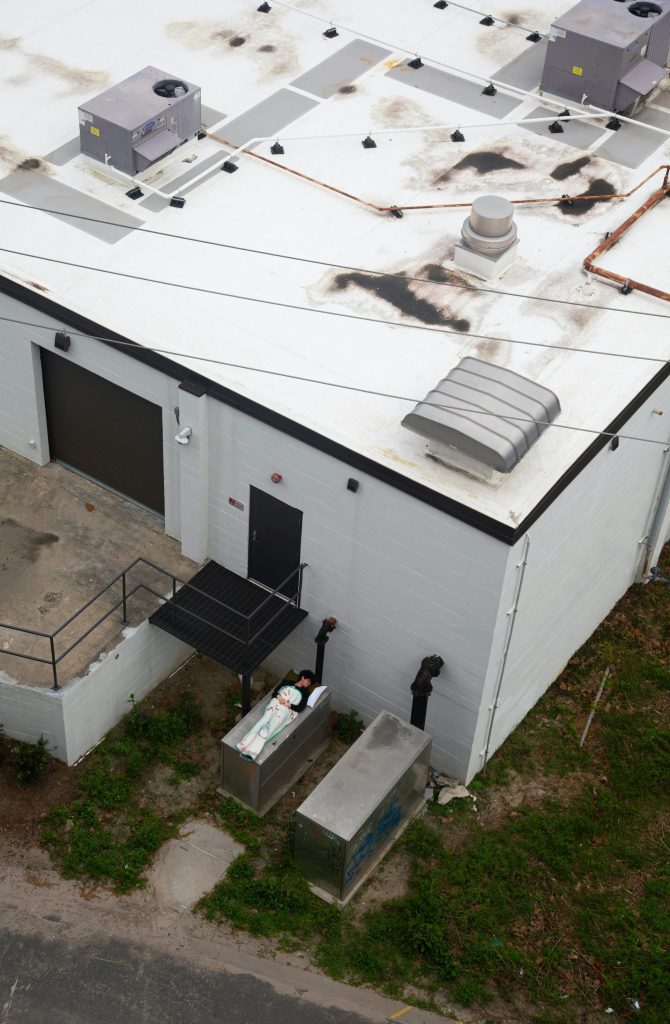 High-angle shot of an industrial building with HVAC units on the roof.